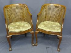 VINTAGE MAHOGANY BERGERE ARMCHAIRS, a pair, having canework backs and seats, carved detail on ball