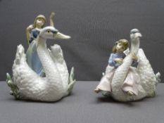 LLADRO - a non-matching pair of a young girl riding a white swan, one standing and one sitting