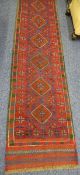 MESHWANI RUNNER - red ground with repeating diamond central pattern and double bordered edge, 260