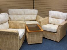 FOUR PIECE CONSERVATORY SUITE of two seater couch, matching armchairs, all having oatmeal