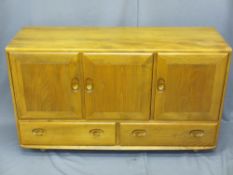 ERCOL SIDEBOARD, mid tone having three cupboard doors and twin lower drawers with carved wooden