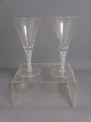 PAIR OF DRINKING GLASSES with air twist stems, conical shaped with circular foot (slight grit/bubble