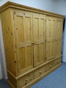 PINE WARDROBE with four doors and four base drawers, 202 x 223 x 58cms