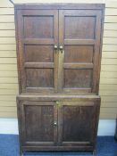 CIRCA 1820 NORTH WALES OAK PRESS CUPBOARD, two piece of peg joined construction having twin upper