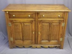 REPRODUCTION OAK DRESSER BASE of two drawers and two cupboard doors with brass knobs with shaped