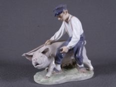 ROYAL COPENHAGEN FIGURINE of a man controlling his sow, Nos '8Y8' to the base with letters 'DDX'