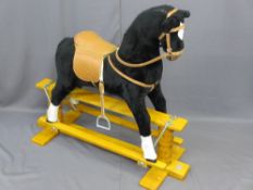 MID-CENTURY VINTAGE ROCKING HORSE on a platform base with 'Thoroughbred' makers label, 105cms