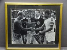 FRAMED PICTURE OF BOBBY CHARLTON, the Manchester United Captain shaking hands with his opposing