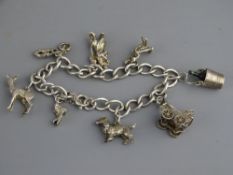 SILVER CHARM BRACELET with eight charms, 34grms gross