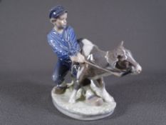ROYAL COPENHAGEN FIGURINE of a young farm boy struggling to control his calf, No to the base '