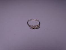 THREE STONE DIAMOND DRESS RING, unmarked, possibly white gold, size P, 1.9grms