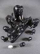 A TRAIN OF SIX GRADUATED EBONIZED ELEPHANTS and a herd of eight standing ebonized elephants, various