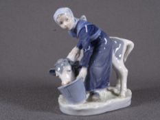 ROYAL COPENHAGEN FIGURINE of a Maiden with her calf feeding from a bucket, No '779' to the base with