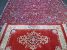 TWO RED GROUND RUGS, 240 x 213cms and 160 x 92cms