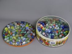 VINTAGE GLASS MARBLES, a quantity in a lidded toffee tin