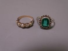 WHITE METAL DRESS RING with oblong green stone and surrounding CZ clusters, 3.2grms O fit and an