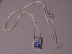 18CT WHITE GOLD GRADUATED SATURATION TANZANITE PENDANT WITH CHAIN, the tanzanites graded in colour
