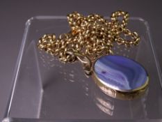 9CT GOLD AGATE & BLUE GOLDSTONE OVAL PENDANT in an attractive mount and having a 60cms 9ct gold
