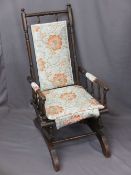 CIRCA 1900 AMERICAN ROCKER with floral re-upholstery, 108cms H, 54cms W, 45cms seat D