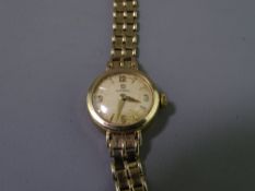 OMEGA 9CT GOLD LADY'S WRISTWATCH with integral bracelet strap, 18grms gross, crown winder and