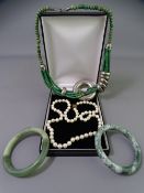 SINGLE STRAND NECKLACE of cultured pearls with 9ct gold clasp, 57cms L, two jadeite bangles with a