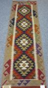 MAIMANA KILIM RUNNER - colourful muted tones on an oatmeal ground with central diamond pattern,