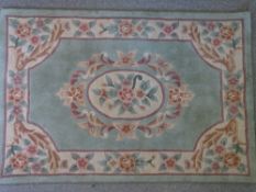 GREEN GROUND CHINESE WASHED WOOLLEN CARPET, 180 x 120cms