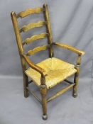 ANTIQUE STYLE LADDERBACK CHILD'S ARMCHAIR, rush seated, 77cms H, 41.5cms W, 28.5cms seat D