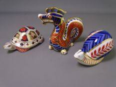 THREE ROYAL CROWN DERBY PAPERWEIGHTS with gold stoppers - snail, tortoise and dragon - all appear as