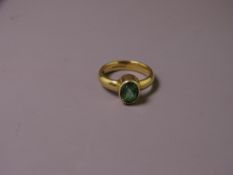 18CT GOLD TOURMALINE DRESS RING having an oval faceted solitaire, approximately 9.7 x 7mms, visual