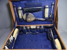 LADIES FITTED TRAVEL/VANITY CASE with protective cover, 24 pieces including silver topped bottles,