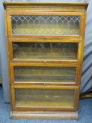 OAK WERNICKE STYLE STACKING BOOKCASE, four section with associated base and top, the upper flap door