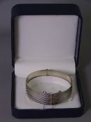 SILVER BANGLE with hinge opening and diamond cut pattern, London 1966, 1.1 troy ozs, 36grms (boxed)