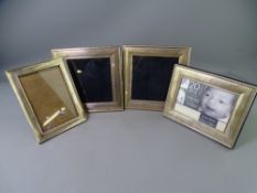FOUR HALLMARKED SILVER PHOTOGRAPH FRAMES including a vintage example, 17 x 12.5cms and three