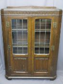 VINTAGE OAK BOOKCASE CABINET having leaded glass doors with linenfold carved lower detail, 124cms H,
