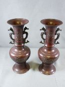 PAIR OF BRONZE ORIENTAL VASES with seahorse handles, 33cms H