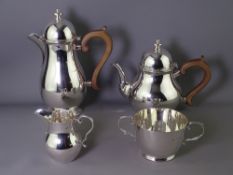 SILVER FOUR PIECE TEA & COFFEE SET in Queen Anne style, domed tops with silver finials over