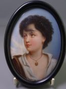 PAINTED PORCELAIN PORTRAIT MINIATURE of a young girl, oval format, in an ebonized frame, 14 x 10.