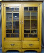 OAK ARTS & CRAFTS BOOKCASE having twin eight panel upper glazed doors with interior adjustable