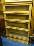 OAK WERNICKE STYLE SECTIONAL BOOKCASE, four flight with top cover and base section and pull-out/