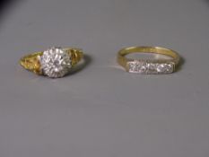 TWO EIGHTEEN CARAT GOLD DIAMOND SET DRESS RINGS including a five stone example in a trough