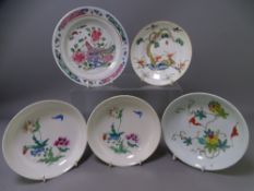 FIVE ORIENTAL PORCELAIN DISHES/SAUCERS having various enamel decoration including a bat and fruit