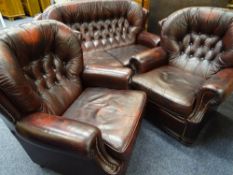 THREE PIECE LOUNGE SUITE, burgundy leather effect, button backed comprising two seater couch,