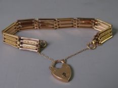 NINE CARAT GOLD FOUR BAR GATE LINK BRACELET with padlock clasp and safety chain, 18.9grms gross