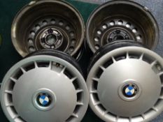 SET OF FOUR BMW WHEELS with clip-on plastic trims (see image for sizes)