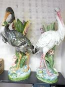 PAIR OF CONTINENTAL POTTERY STICKSTANDS, a fine pair depicting storks and lilies (A/F), 92cms H