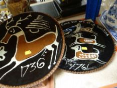 TWO SLIP DECORATED POTTERY CHARGERS BY D. WEAKE of fox hunting and of a stag with butterfly, slip