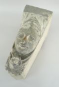ARCHITECTURAL KEYSTONE carved with the face of a woman in the medieval style
