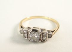 ART DECO DESIGN SEVEN STONE DIAMOND RING in yellow metal setting, the primary stone 0.3cts
