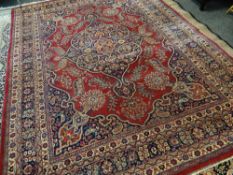 TABRIZ RUG with blue arabesque medallion and spandrels on red palmette ground, multiple borders